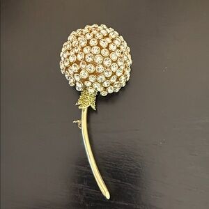 dandelion brooch featuring clear rhinestone embellishments on a gold-toned stem